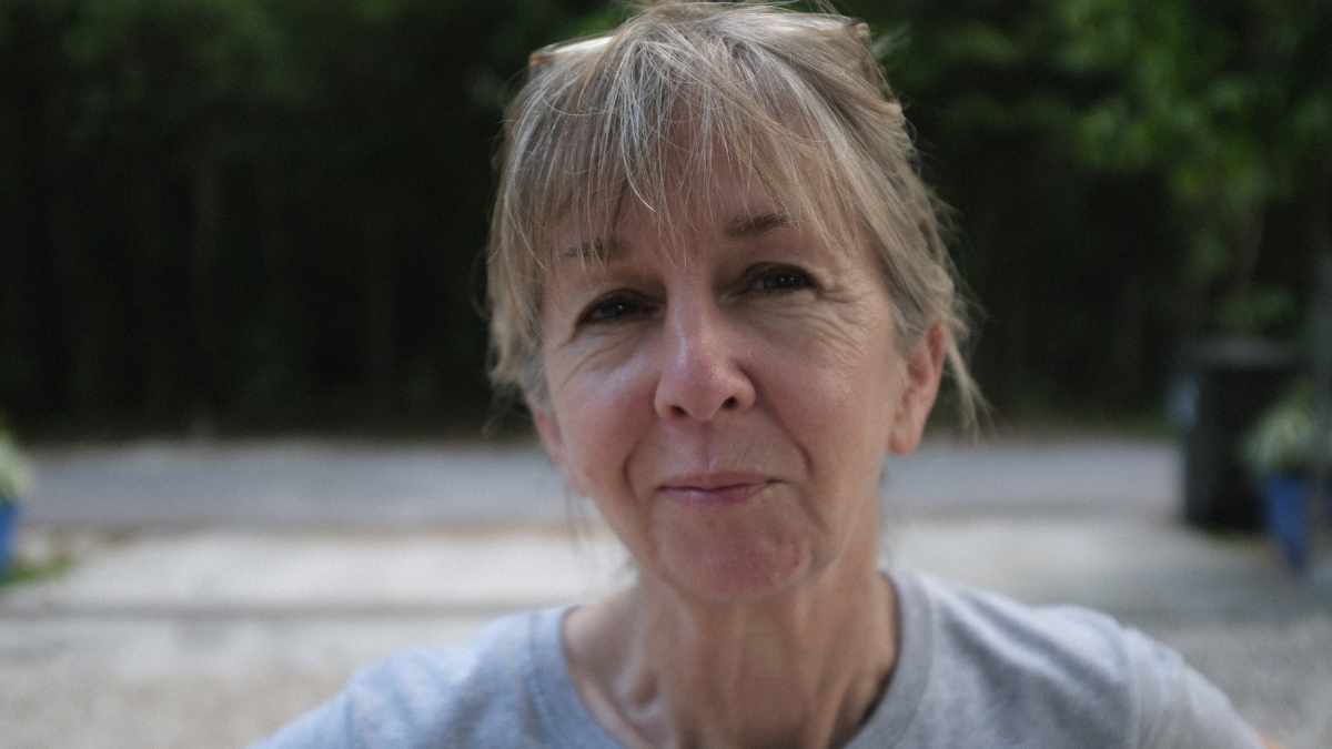 Mujer mayor de 60 años sonriendo con serenidad y plenitud