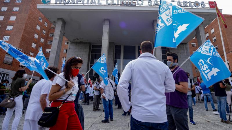 Varios sanitarios se concentran con pancartas como signo de protesta frente al Hospital Clínico San Carlos, en Madrid