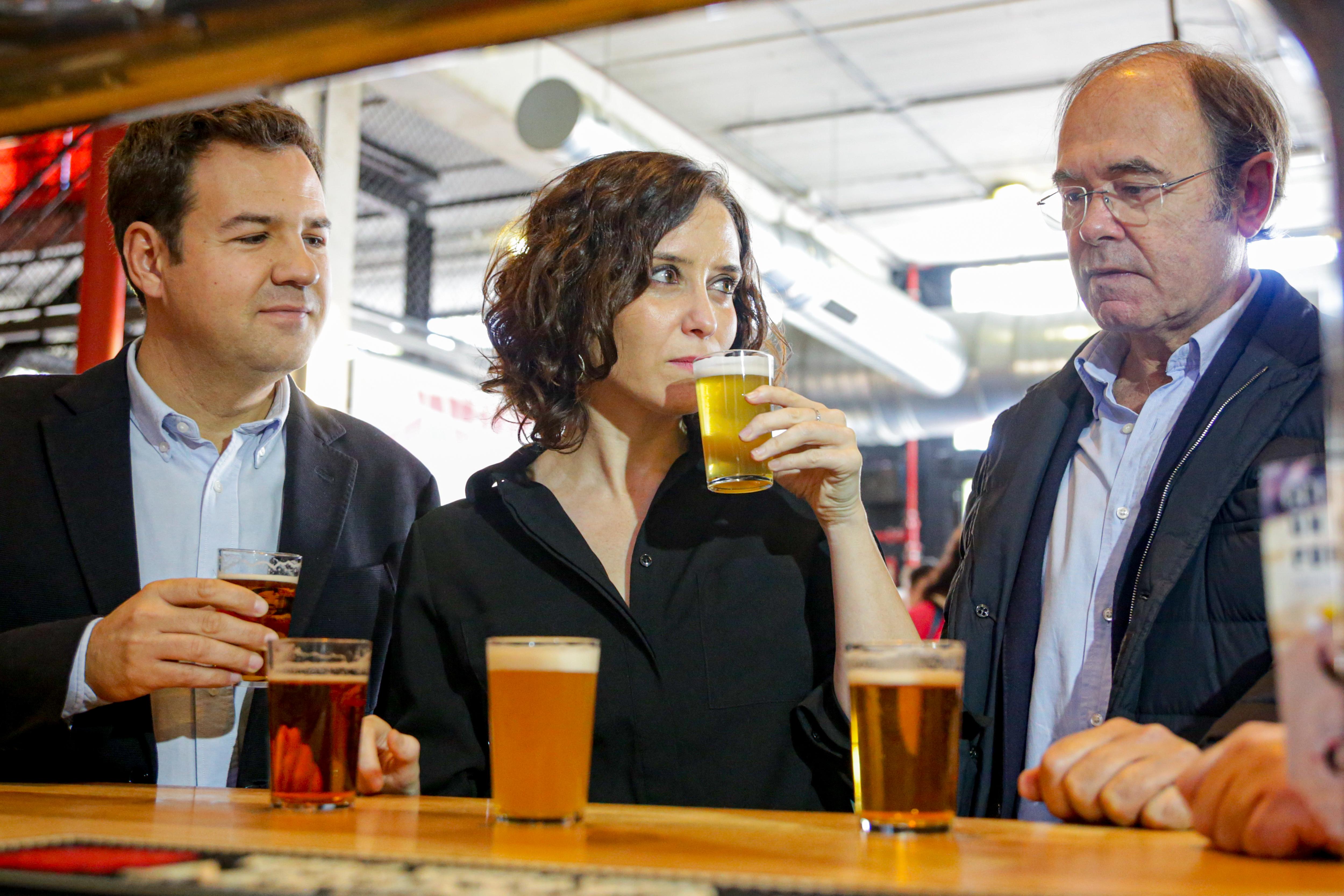 (I-D) El alcalde de Las Rozas, José de la Uz; la presidenta de la Comunidad de Madrid, Isabel Díaz Ayuso; y el presidente del partido en Madrid, Pío García Escudero, visitan la fábrica de cerveza artesanal 'La Virgen', en Las Rozas (Madrid), a 8 de noviem