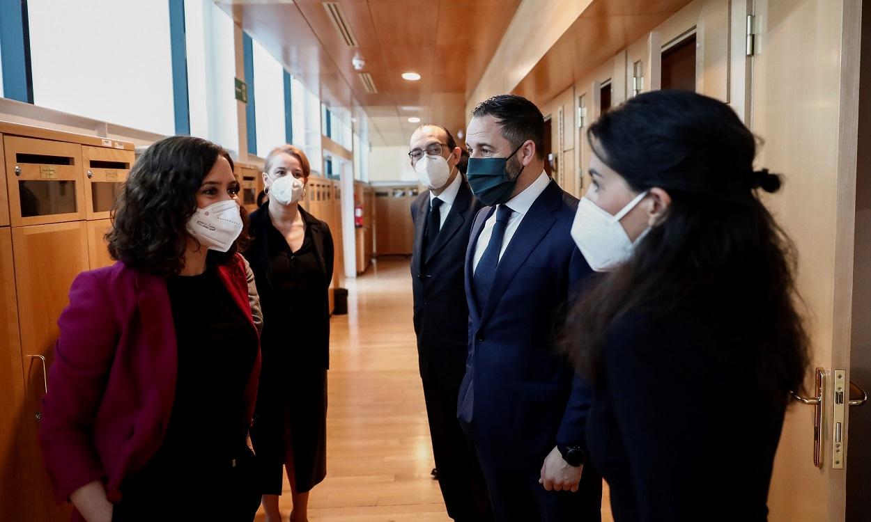 Foto de archivo de la presidenta en funciones de la Comunidad de Madrid, Isabel Díaz Ayuso (i) conversa con la candidata de Vox, Rocío Monasterio (d) en presencia del líder de Vox, Santiago Abascal (2d). EP