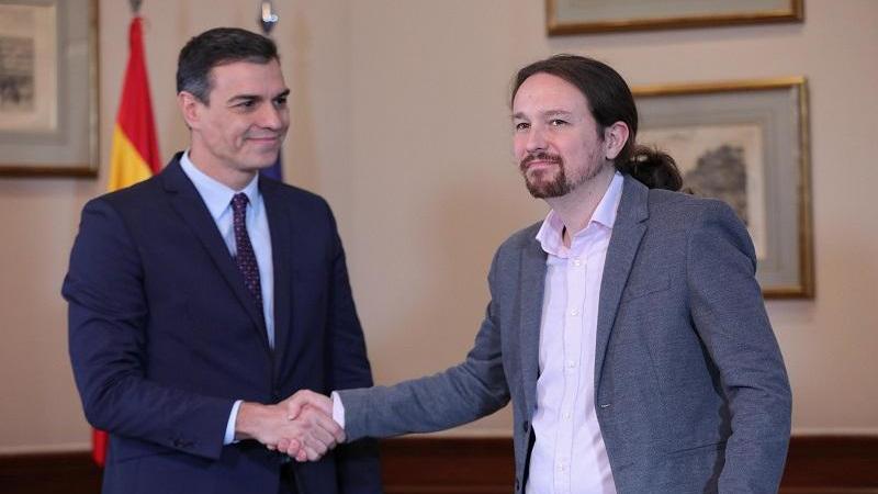 Pedro Sánchez y Pablo Iglesias se dan la mano durante una reunión, ambos en el Gobierno de coalición