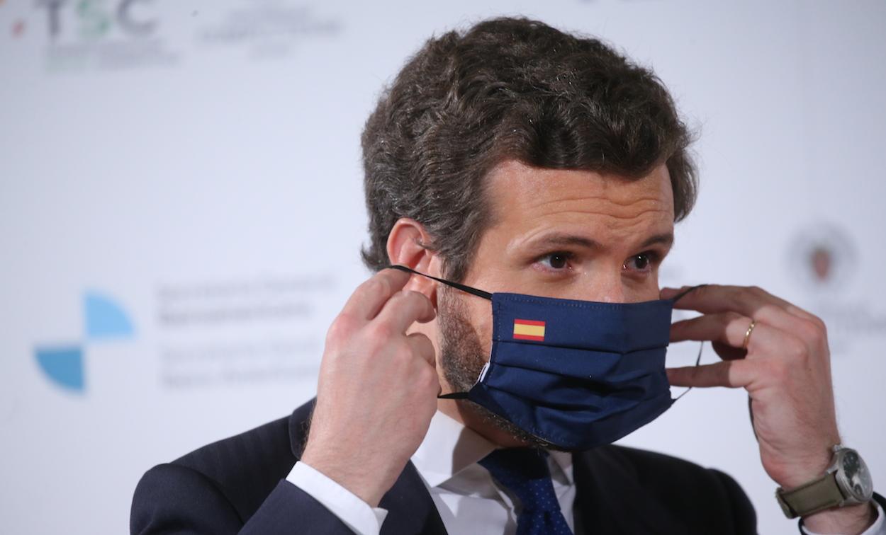 El líder del PP, Pablo Casado, colocándose la mascarilla con la bandera de España. ISABEL INFANTES/EP