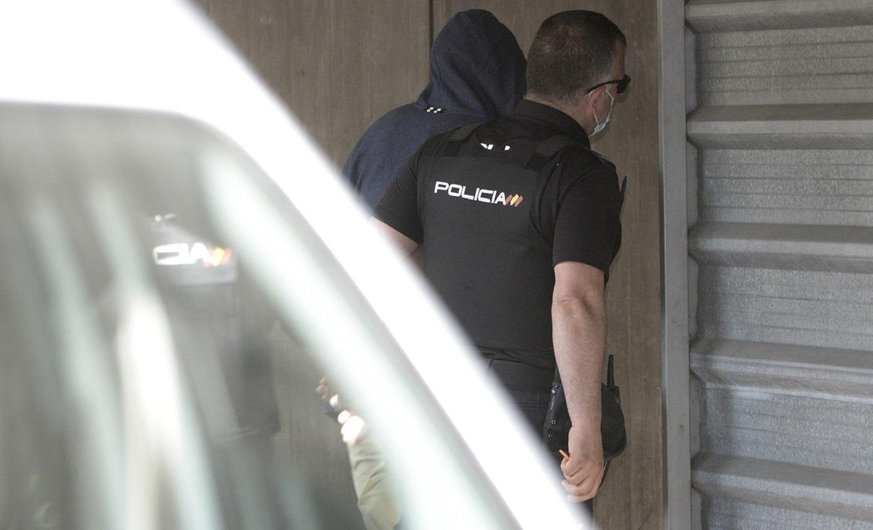 Un agente lleva arrestado a uno de los acusados para declarar como presunto autor de la paliza que causó la muerte a Samuel Luiz en A Coruña . EP