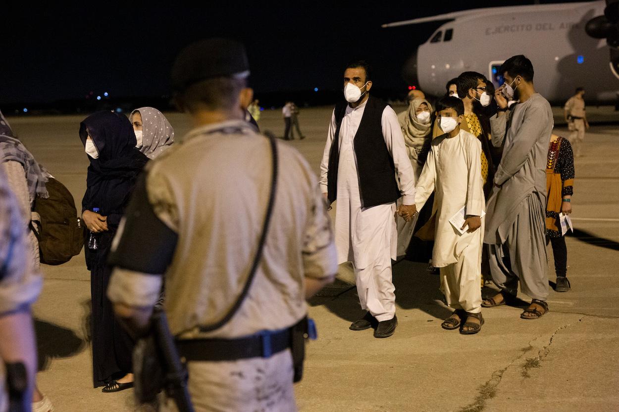 arias personas repatriadas llegan a la pista tras bajarse del avión A400M en el que ha sido evacuados de Kabul, a 19 de agosto de 2021