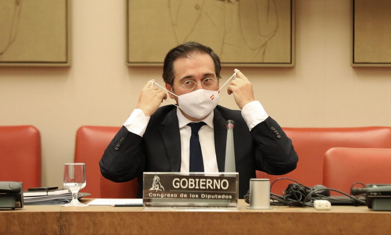 El ministro de Asuntos Exteriores, Unión Europea y Cooperación, José Manuel Albares, se pone la mascarilla durante una comparecencia en una rueda de prensa sobre la crisis de Afganistán,