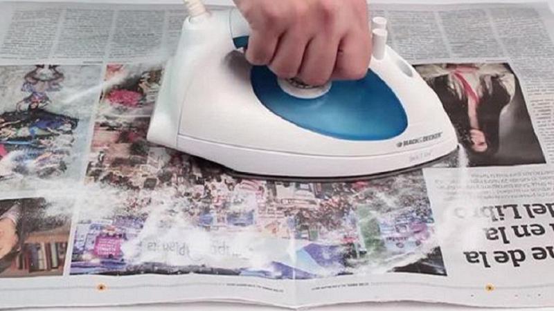 Limpiar la base de la plancha con papel de periódico