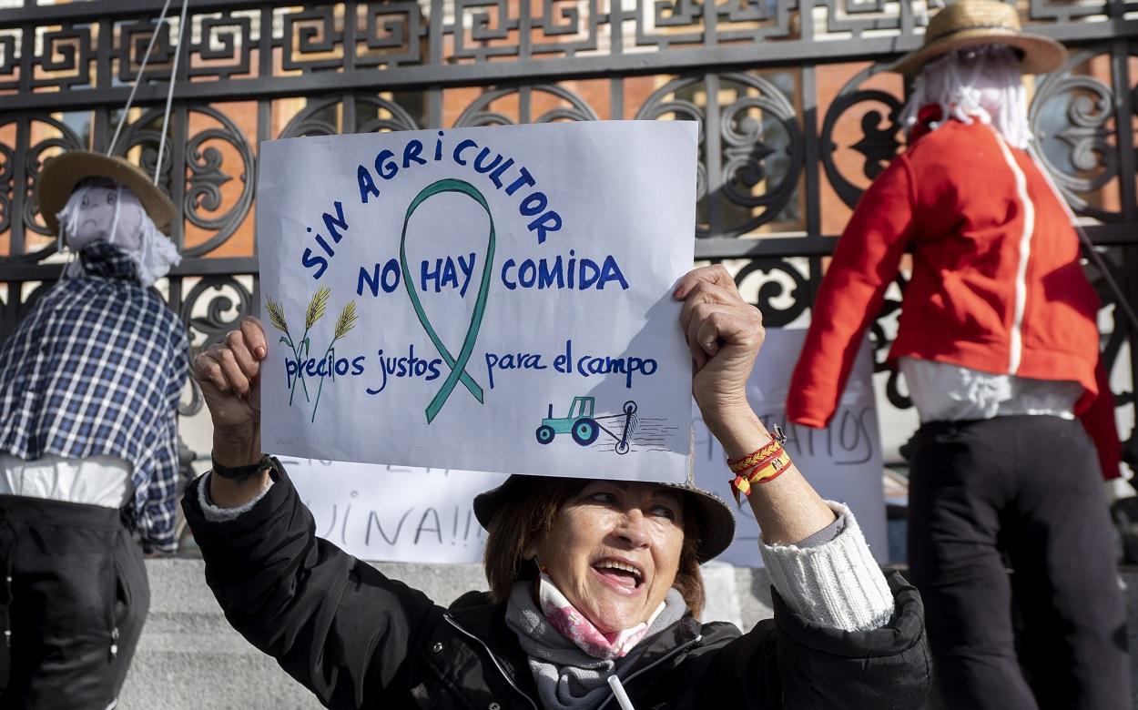 Una de las manifestantes sostiene una pancarta en defensa de los agricultores. Europa Press