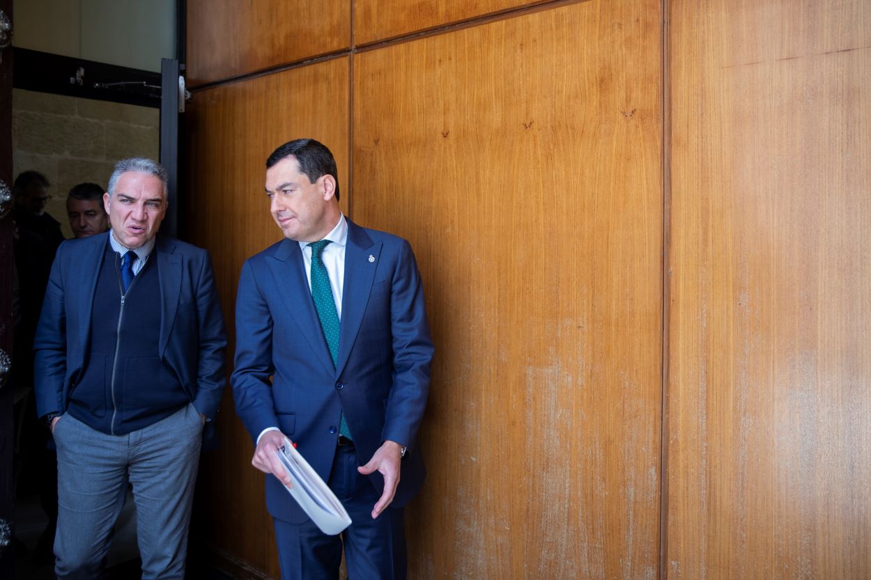 El presidente andaluz, Juan Manuel Moreno, con el coordinador general del PP, Elías Bendodo, en el Parlamento andaluz. MARIA JOSÉ LÓPEZ/EP