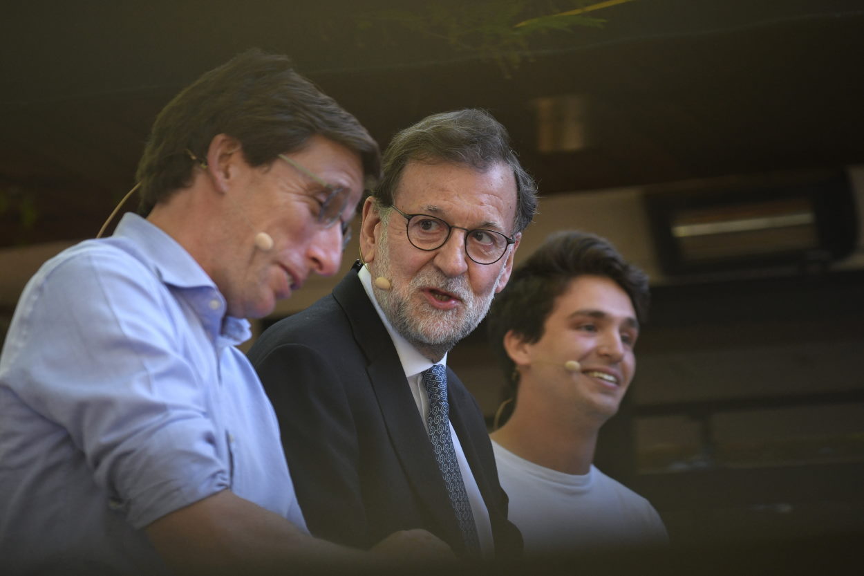 El expresidente del Gobierno Mariano Rajoy (c), junto al alcalde de Madrid, José Luis Martínez Almeida (i), y el presidente de NNGG, Ignacio Dancausa (d), en una terraza de Madrid. Europa Press.