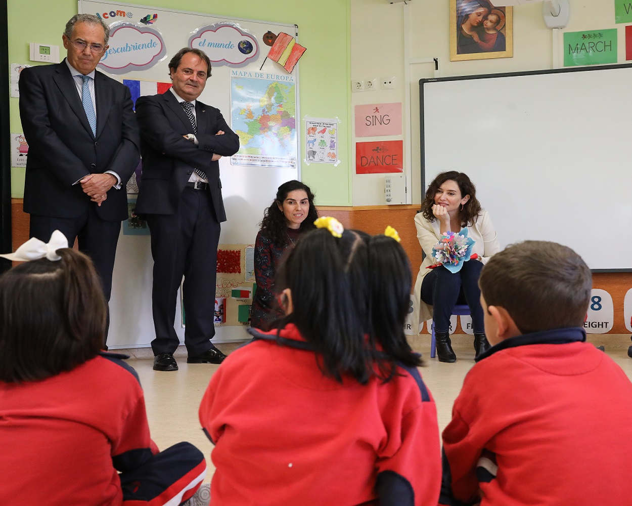 La presidenta de la Comunidad de Madrid, Isabel Díaz Ayuso, con varios niños en el colegio San Agustín. EP