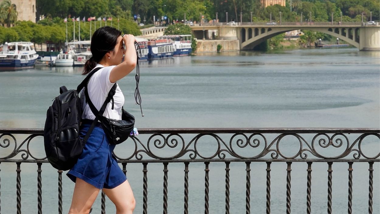 Una persona paseando por el Puente de Triana de Sevilla. EP