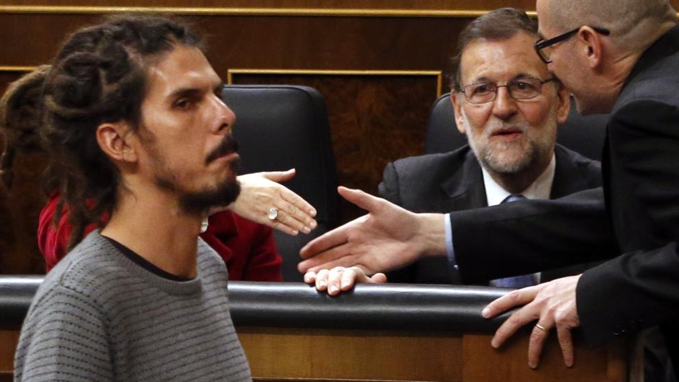El diputado de Podemos Alberto Rodríguez pasa ante el presidente del Gobierno en funciones, Mariano Rajoy