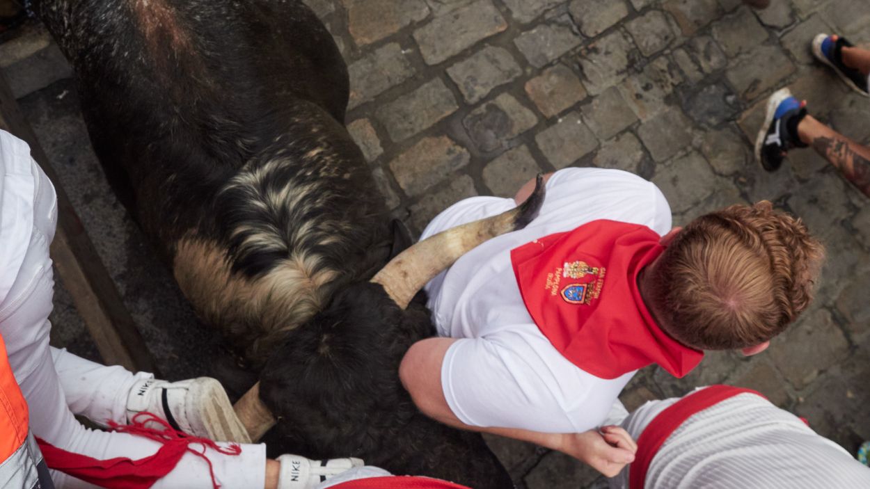 Un corredor delante de un toro durante el tercer encierro de los Sanfermines, a 9 de julio de 2024, en Pamplona, Navarra (España). EP. 