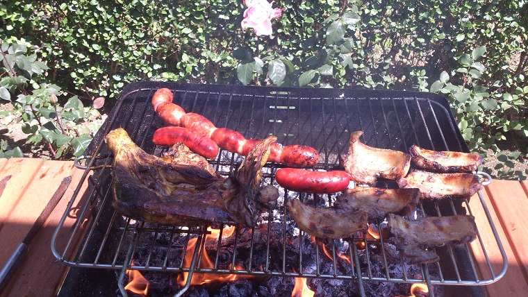 Barbacoa de carne y embutidos frescos y ensalada verde con cebolleta