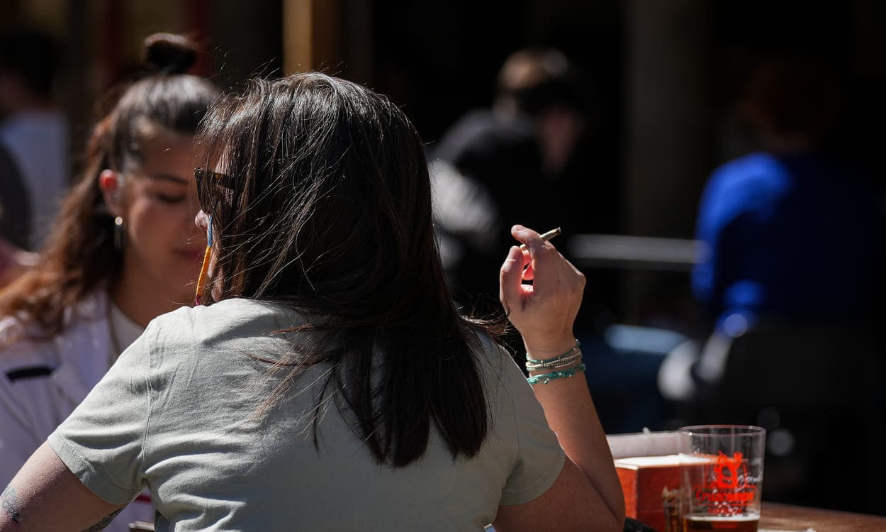 Una persona fumando en una terraza en Sevilla. María José López / EP