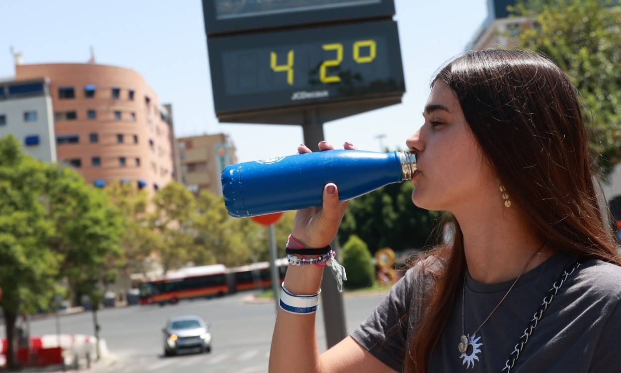 Una joven bebe agua para combatir la ola calor en Sevilla. EP