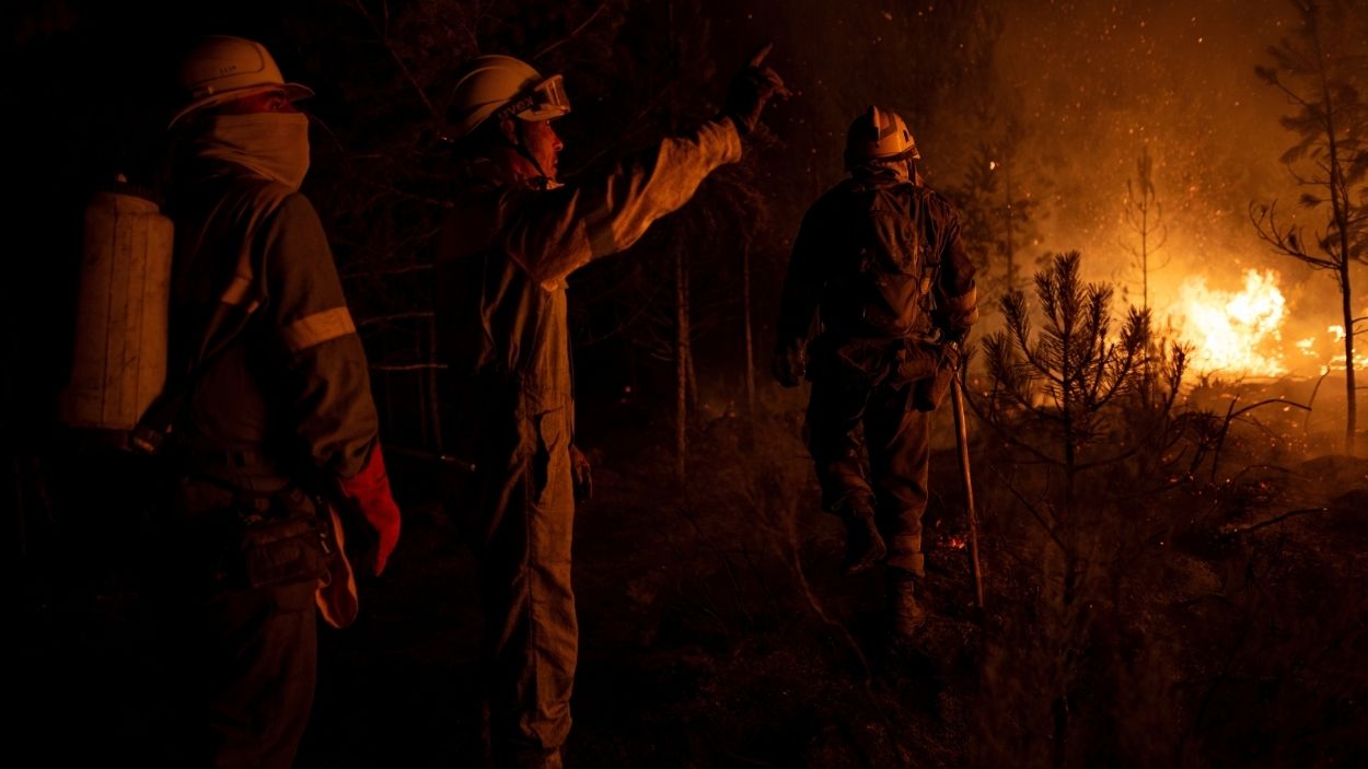 Un grupo de bomberos forestales tratan de extinguir el fuego. EP.