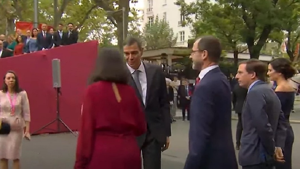 El presidente del Gobierno, Pedro Sánchez, saluda a diferentes autoridades a su llegada al desfile del 12 de Octubre, entre ellas, Isabel Díaz Ayuso. EP