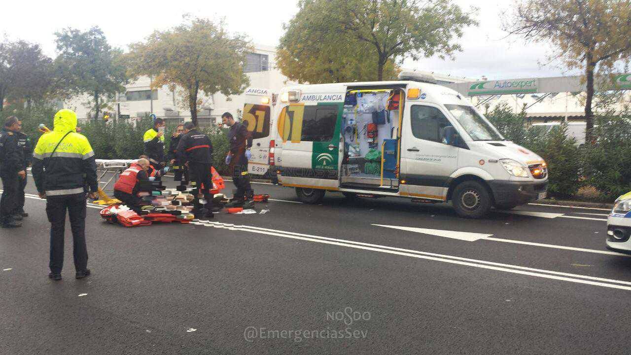 Los servicios de Emergencia atienden al ciclista atropellado en la avenida Montesierra, en Sevilla.