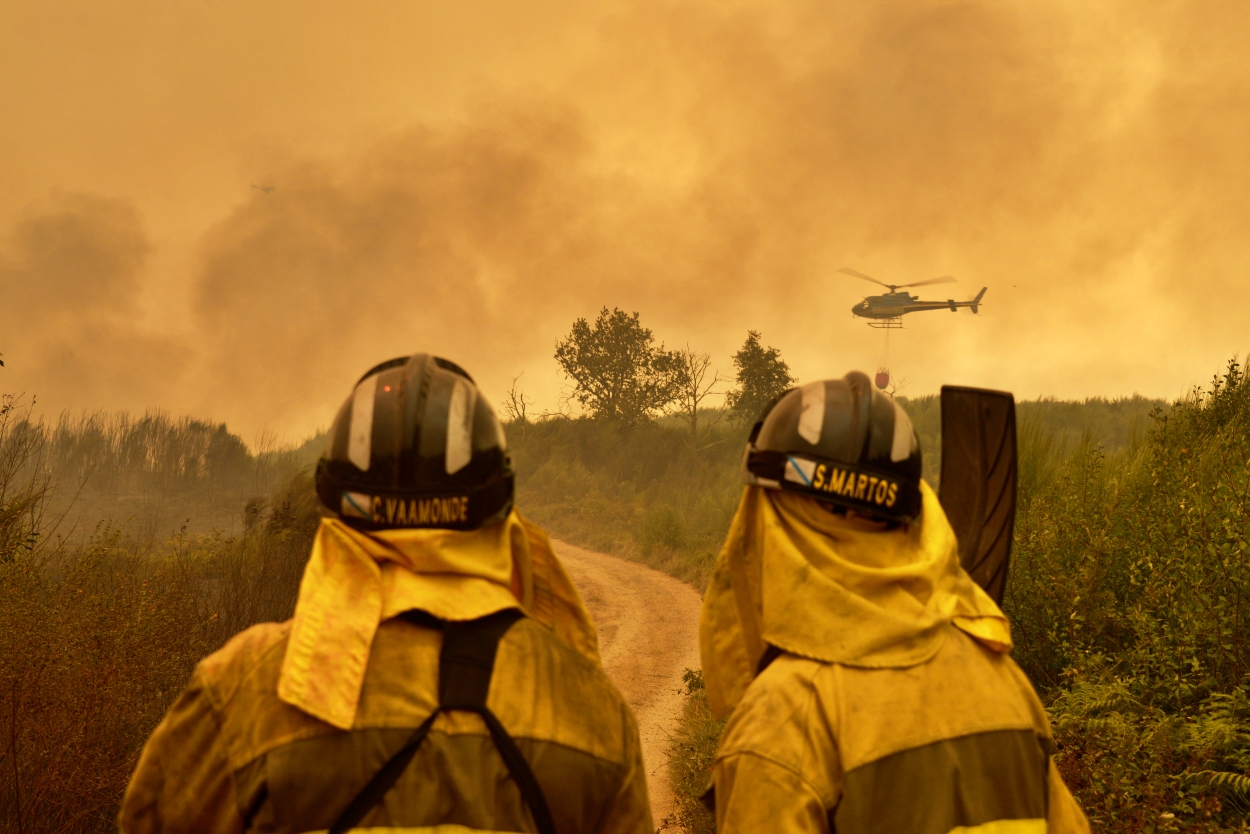 Dos miembros de las brigadas forestales durante la extinción en agosto de 2025 de un incendio en Cualedro, Ourense (Foto: Europa Press).