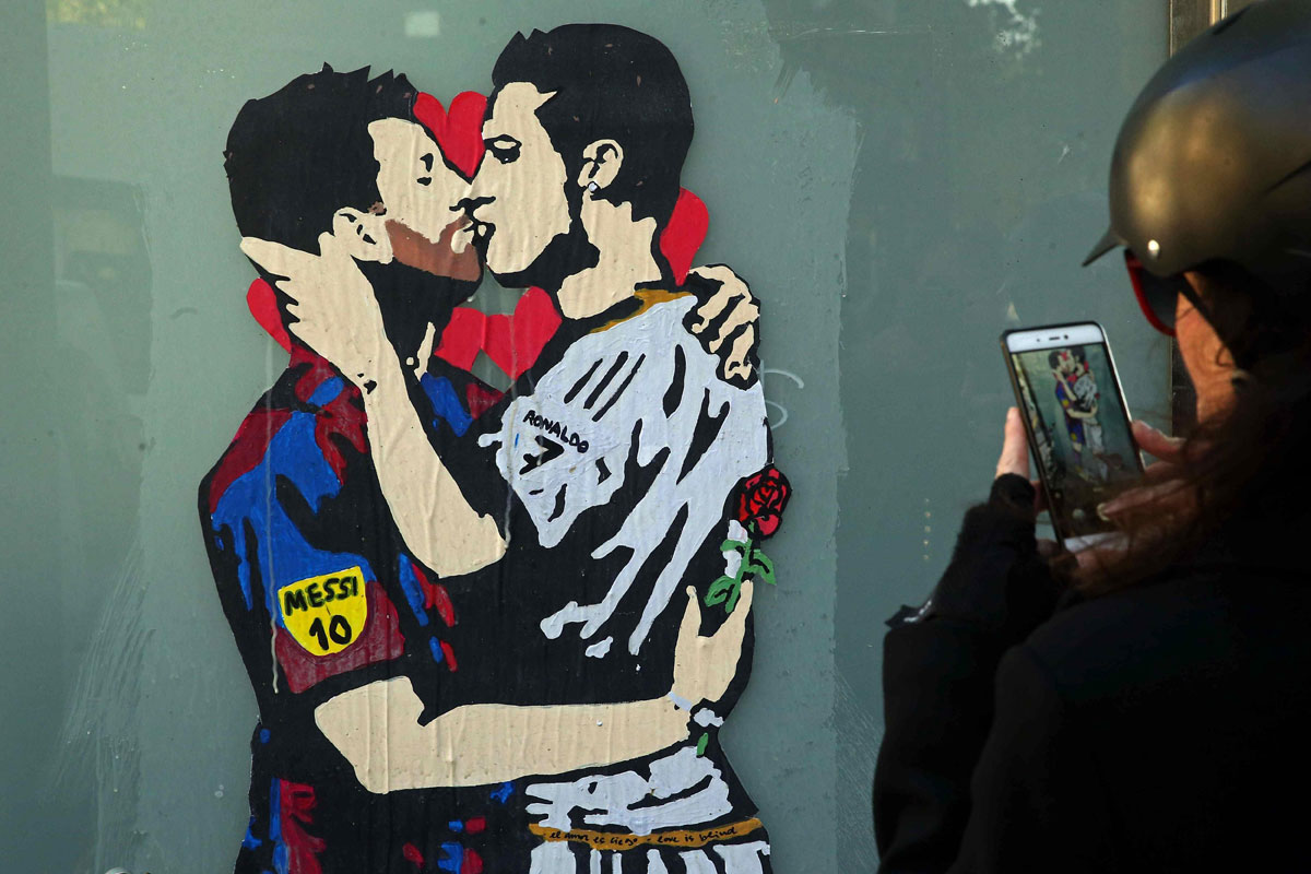 Leo Messi y Cristiano Ronaldo besándose en un grafiti en el centro de Barcelona