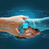 Don brazos se dan la mano bajo un símbolo de inteligencia artificial. SERVIMEDIA