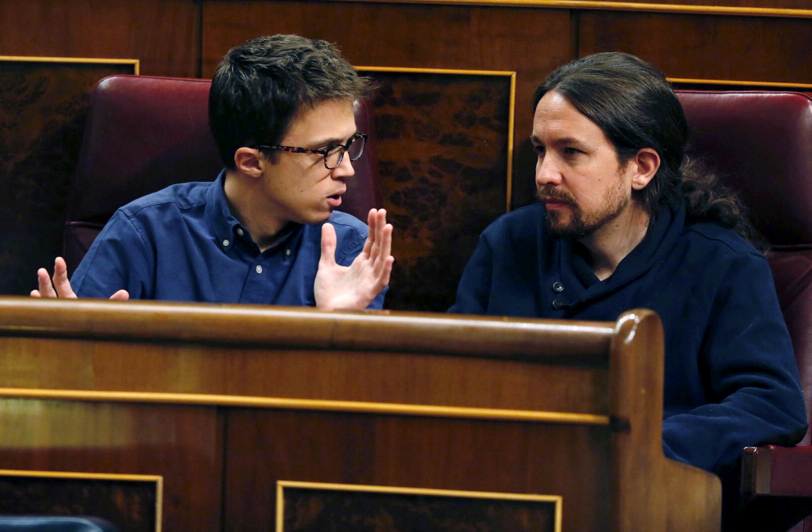Íñigo Errejón y Pablo Iglesias discuten en sus escaños del Congreso.