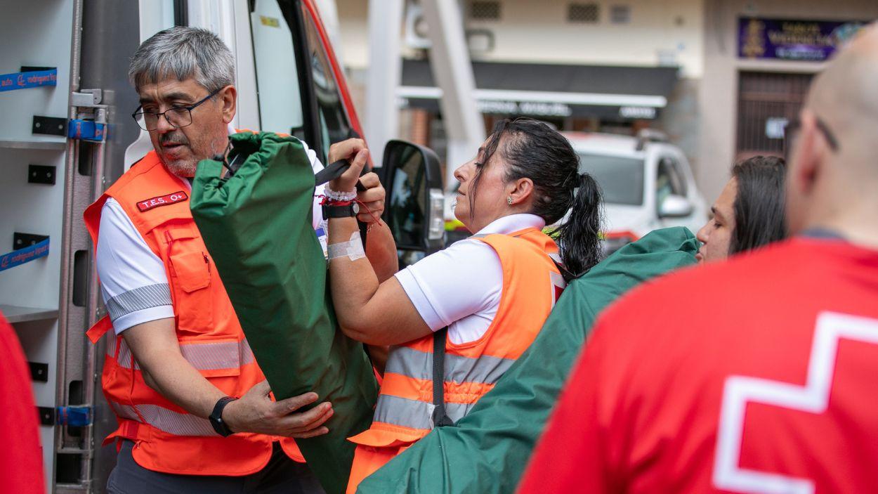 Varios efectivos de emergencias ayudan a personas evacuadas por el incendio de Burgohondo. Europa Press.