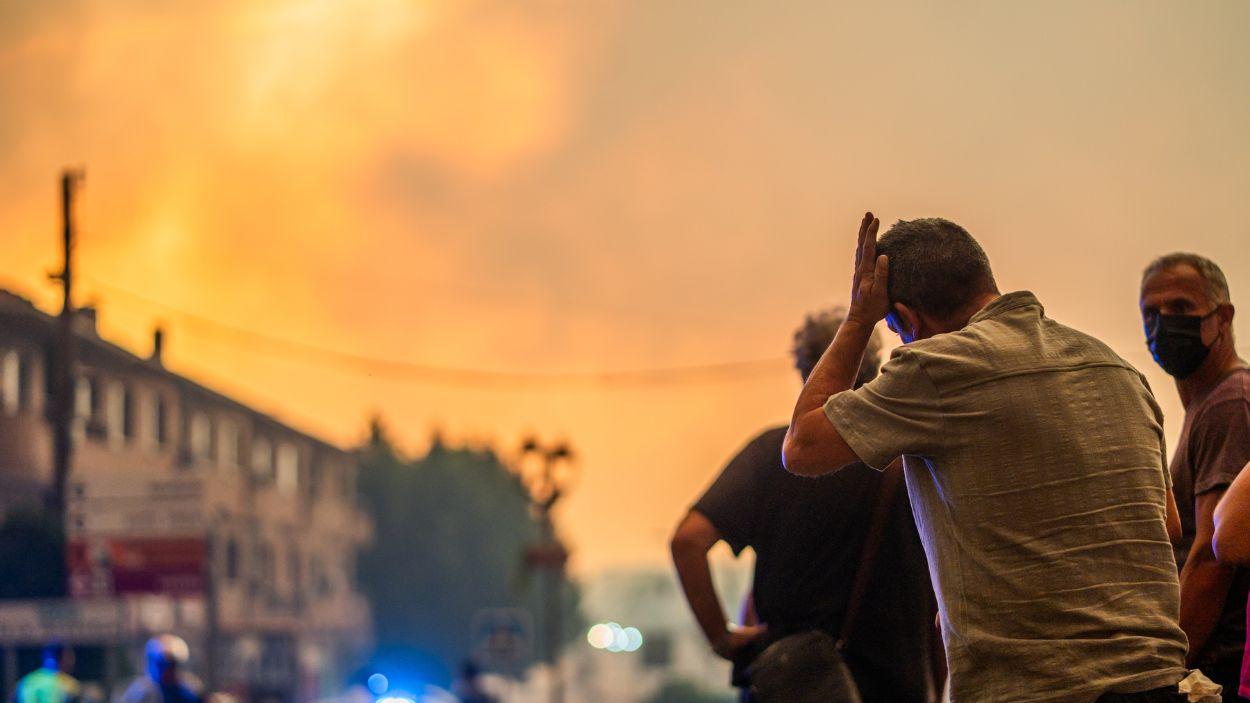 Varias personas observan el fuego durante las labores de extinción en La Adrada (Ávila). Europa Press.