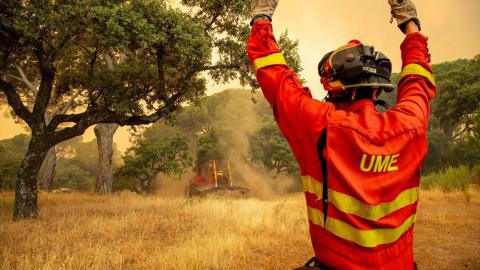 Agente de la UME da instrucciones al bulldozer que trabaja en los Incendios de Pinar de Almorox (Toledo). Tamara Rozas