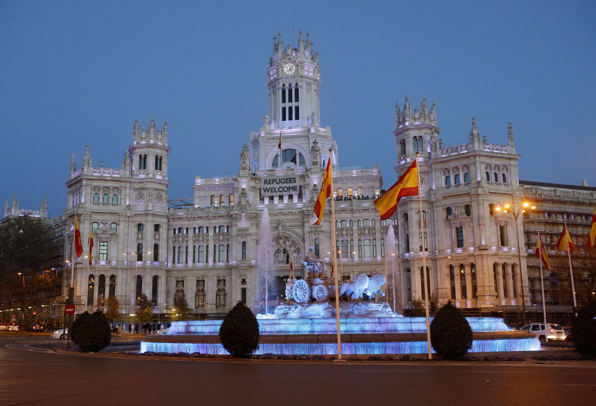 La Real Casa de Correos de la Puerta del Sol, sede del Gobierno de la Comunidad de Madrid, y la fuente de Cibeles, teñidas de azul