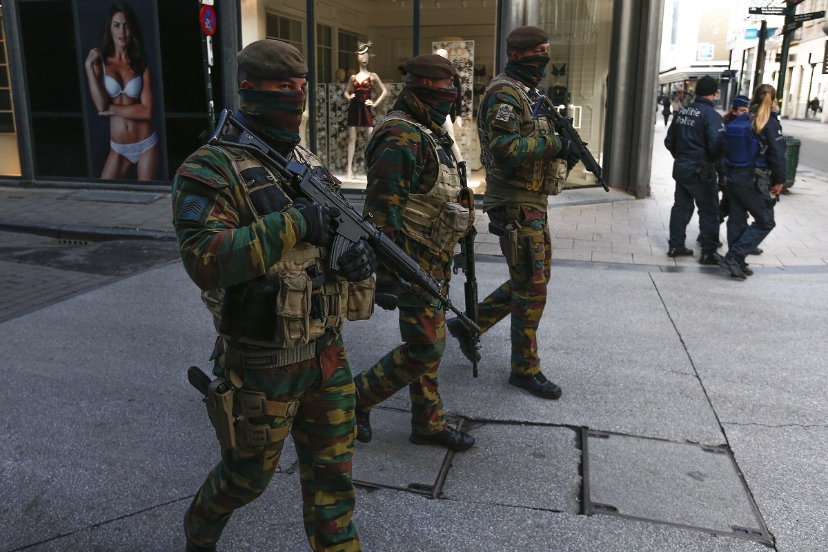 Policías y solados patrullan por una calle de Bruselas. 