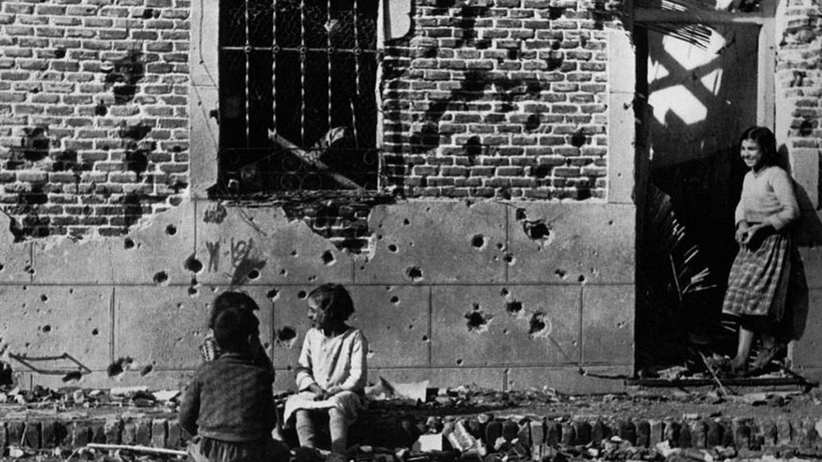 Niños jugando en la fachada bombardeada del edificio de Vallecas.