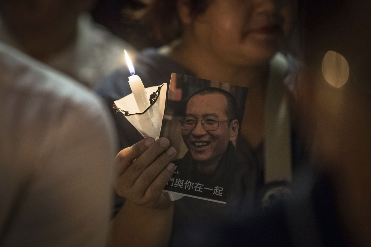 Un activista prodemocrático con una foto del activista del Nobel de la Paz chino Liu Xiaobo durante una vigilia en Hong Kong, China