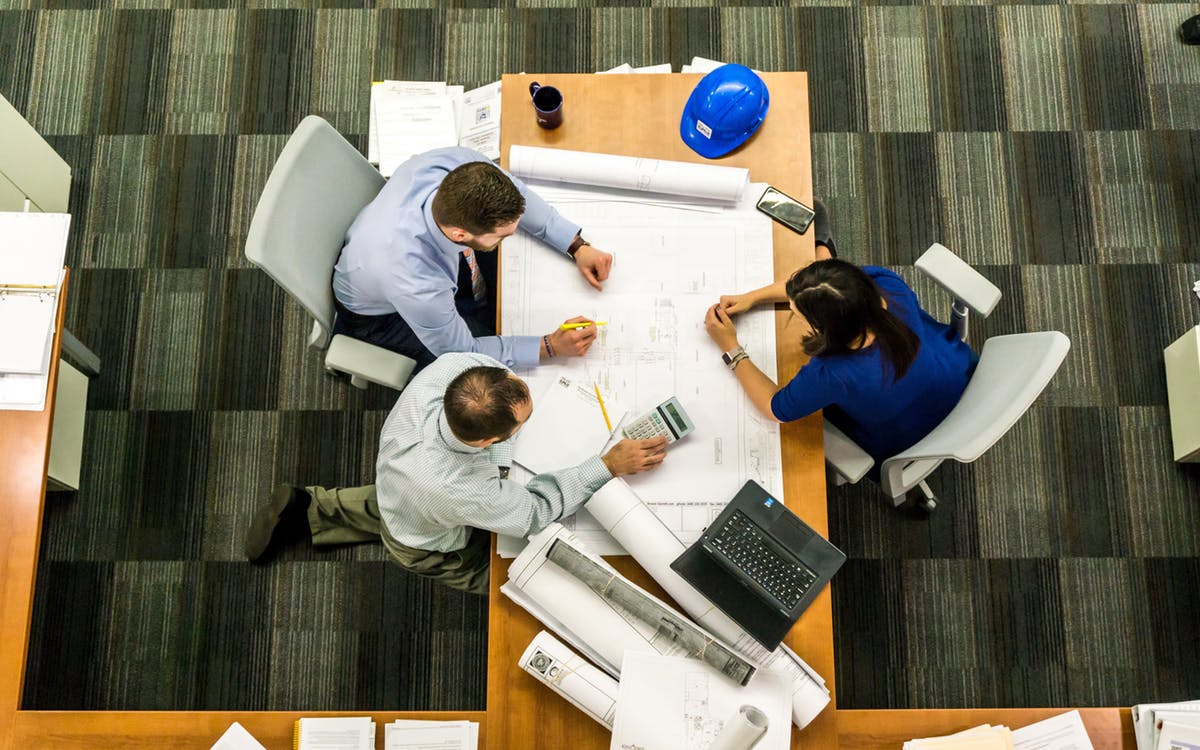 Personas alrededor de una mesa de trabajo en una empresa. Archivo