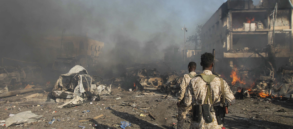 Somali soldiers look on at the scene of a massive explosion in front of Safari Hotel in the capital Mogadishu, Somalia