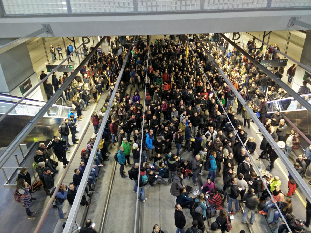 Cientos de personas ocupan las vías del AVE en la estación de Girona durante la jornada de huelga general