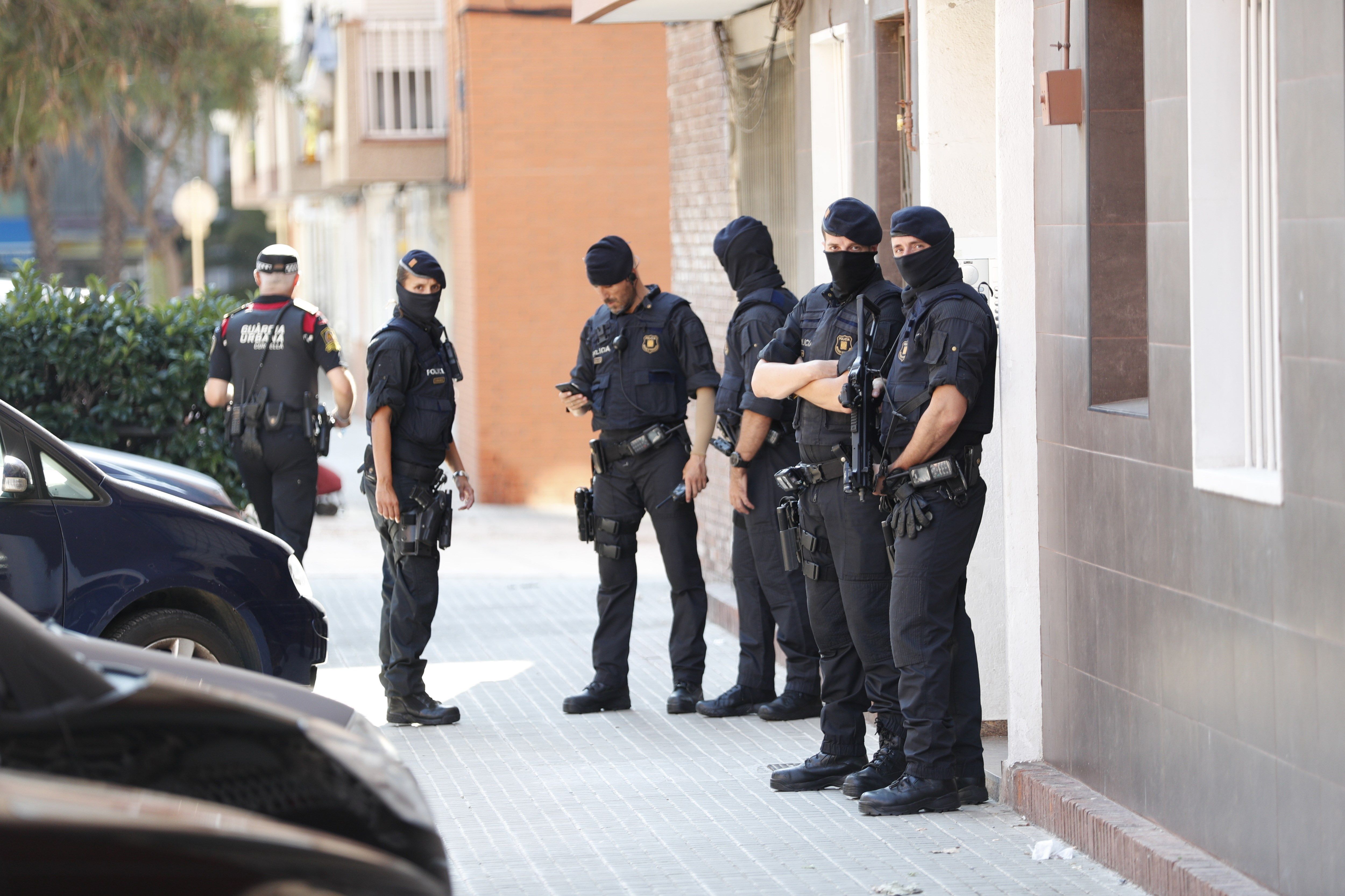 Los Mossos d'Esquadra custodian el edificio donde vivía el que hombre ha sido abatido esta mañana al intentar acceder a la con un cuchillo en la mano y al grito de "Alá es grande" en la comisaría de los Mossos en Cornellà. EFE