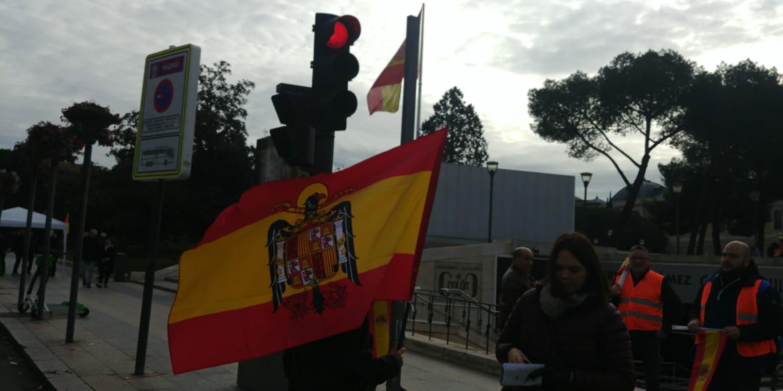 Asistente a la concentración de Vox y Denaes con una bandera franquista