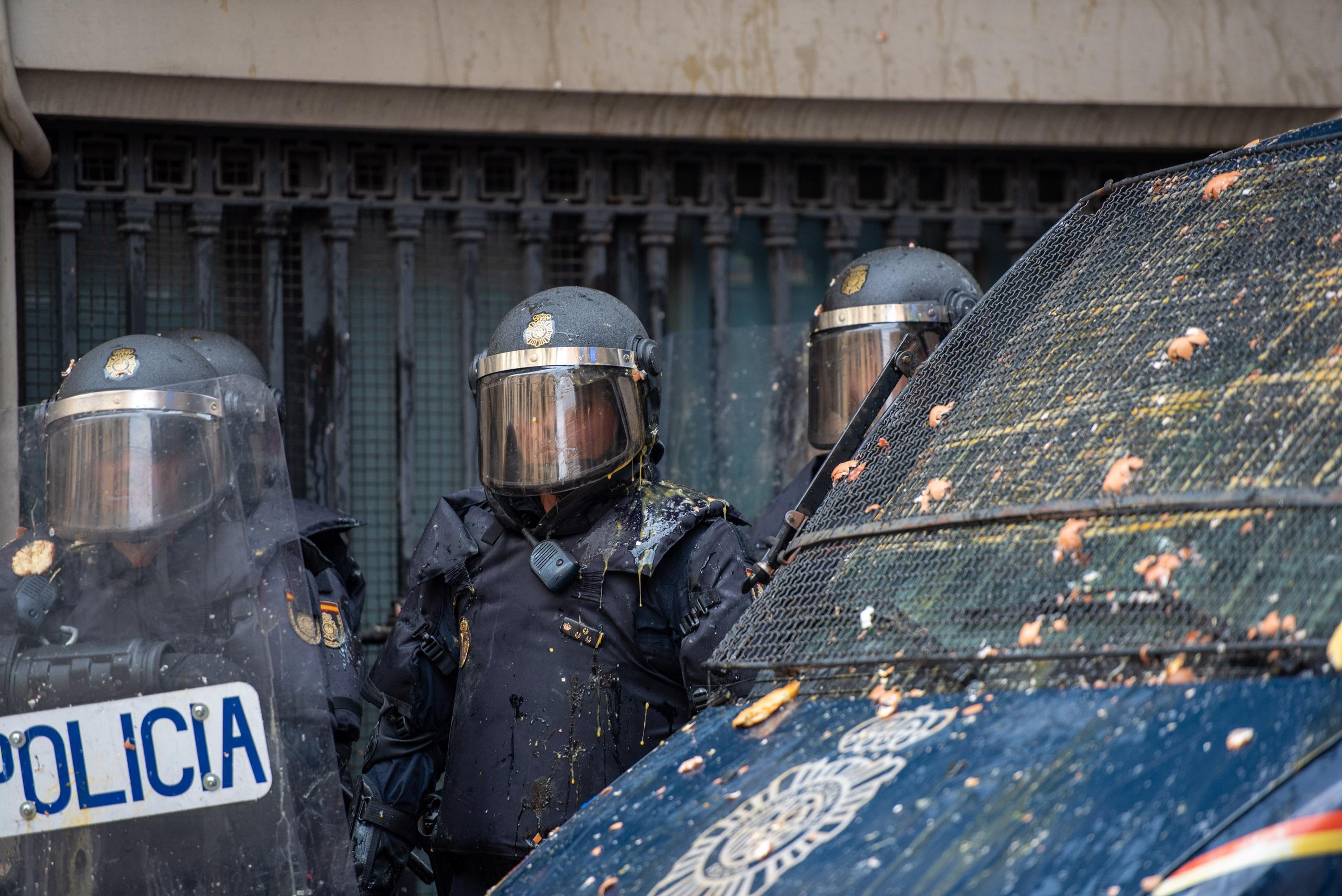 Agentes de la Policía Nacional son alcanzados por balas de pintura. Fuente: Europa Press.
