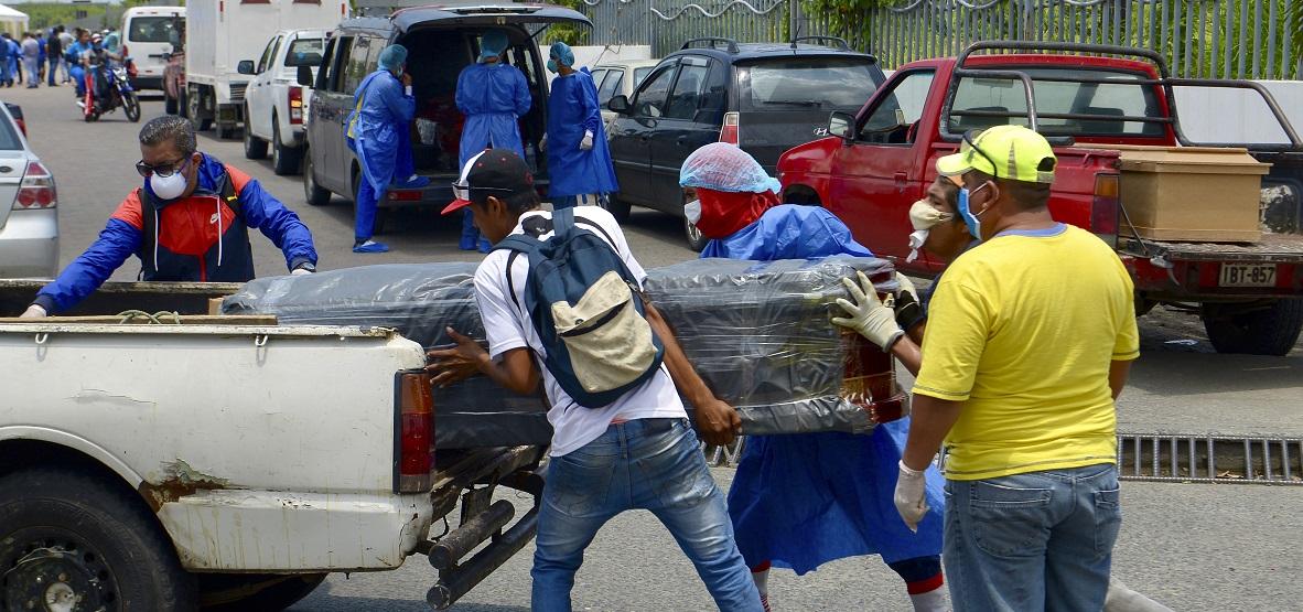 Varias personas introducen en un coche el cadáver de un enfermo de coronavirus en Guayaquil. Foto: Marcos Pin Mendez/DPA