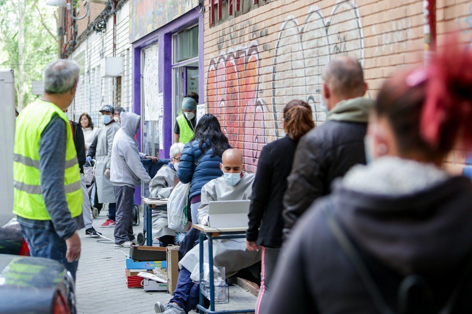  Cientos de personas sin recursos hacen cola en Aluche en busca de "una bolsa de comida