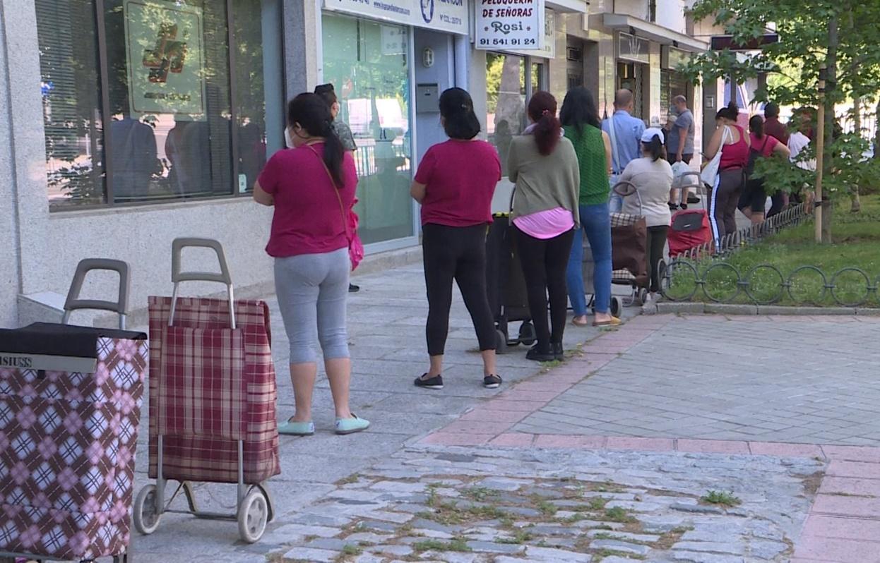 Cola de personas esperando un reparto de alimentos