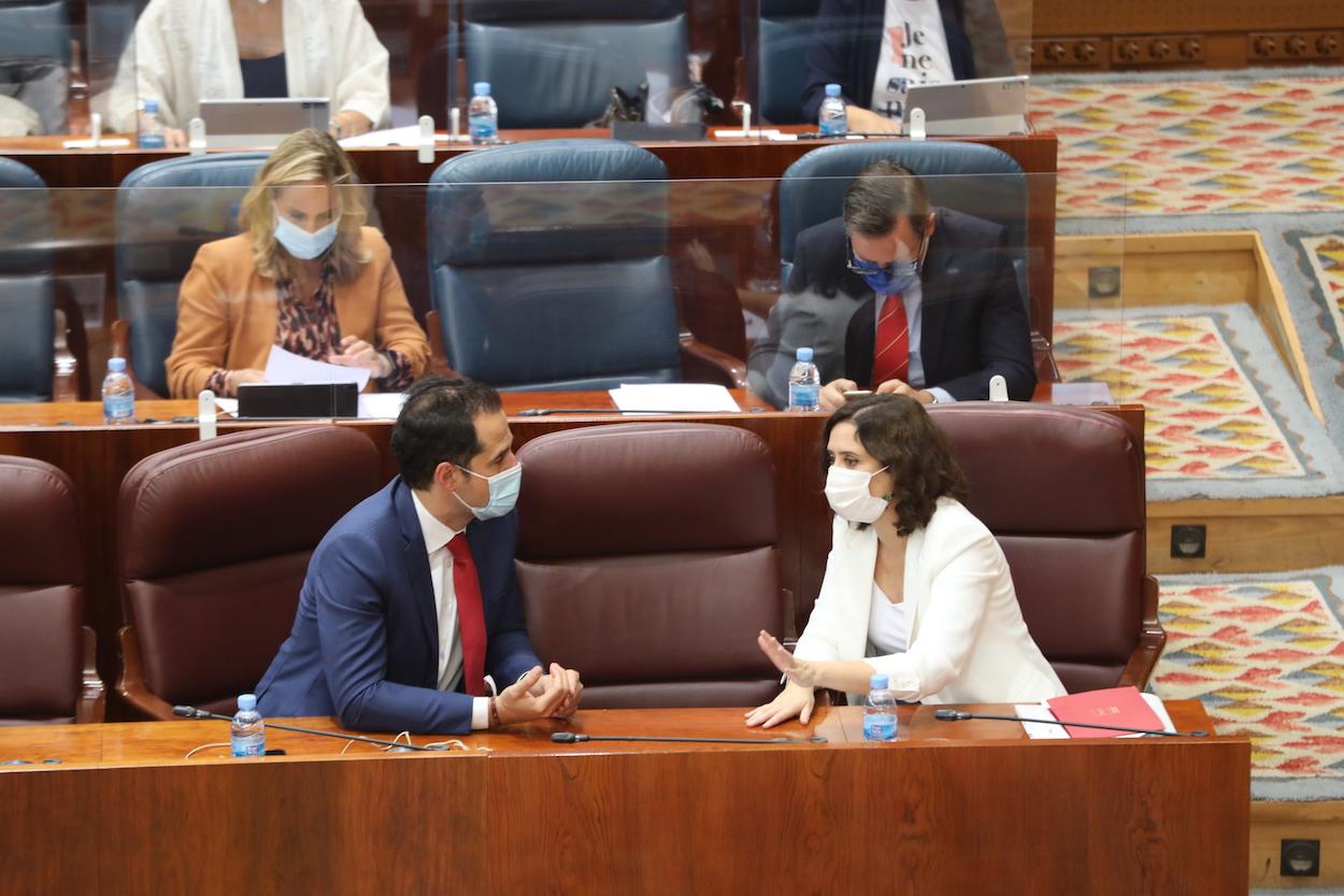 La presidenta de la Comunidad de Madrid, Isabel Díaz Ayuso, habla con el vicepresidente de la Comunidad, Ignacio Aguado, durante una sesión plenaria en la Asamblea de Madrid, en Madrid